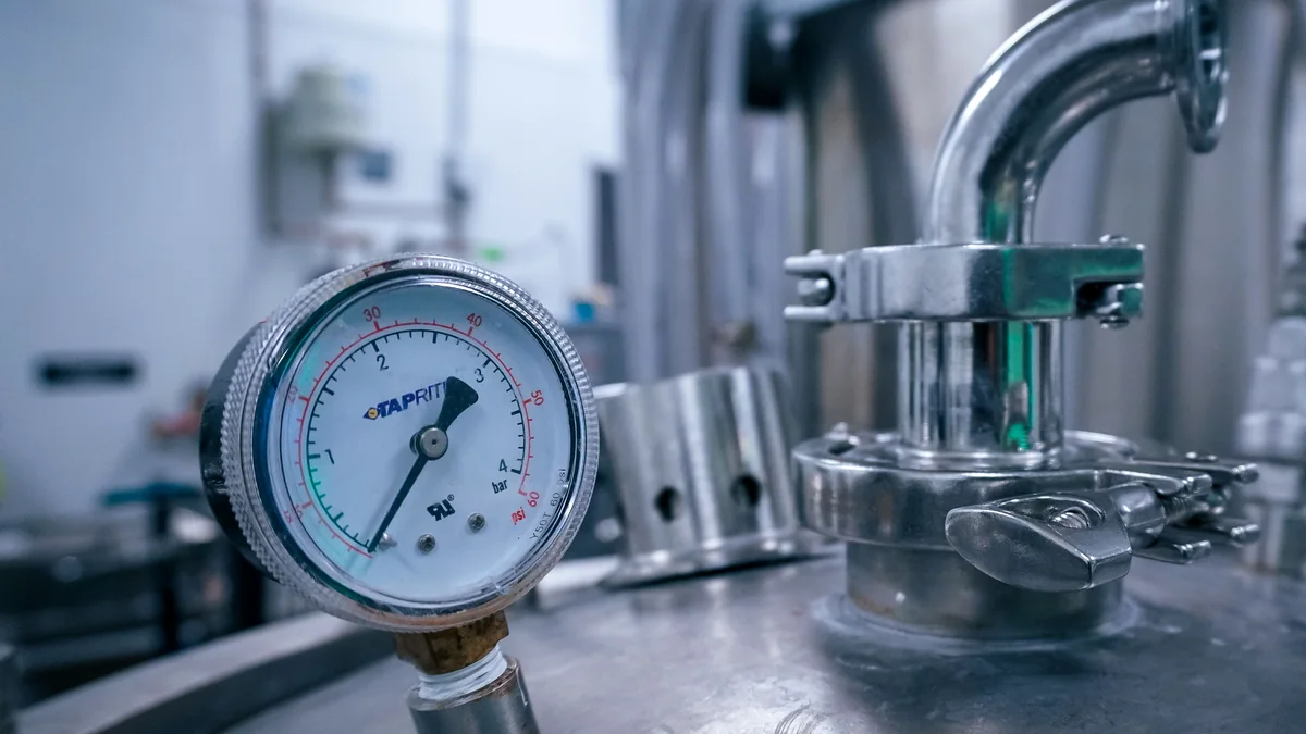 Close view of a pressure gauge and sealed equipment illustrating pump gauge diagnosis