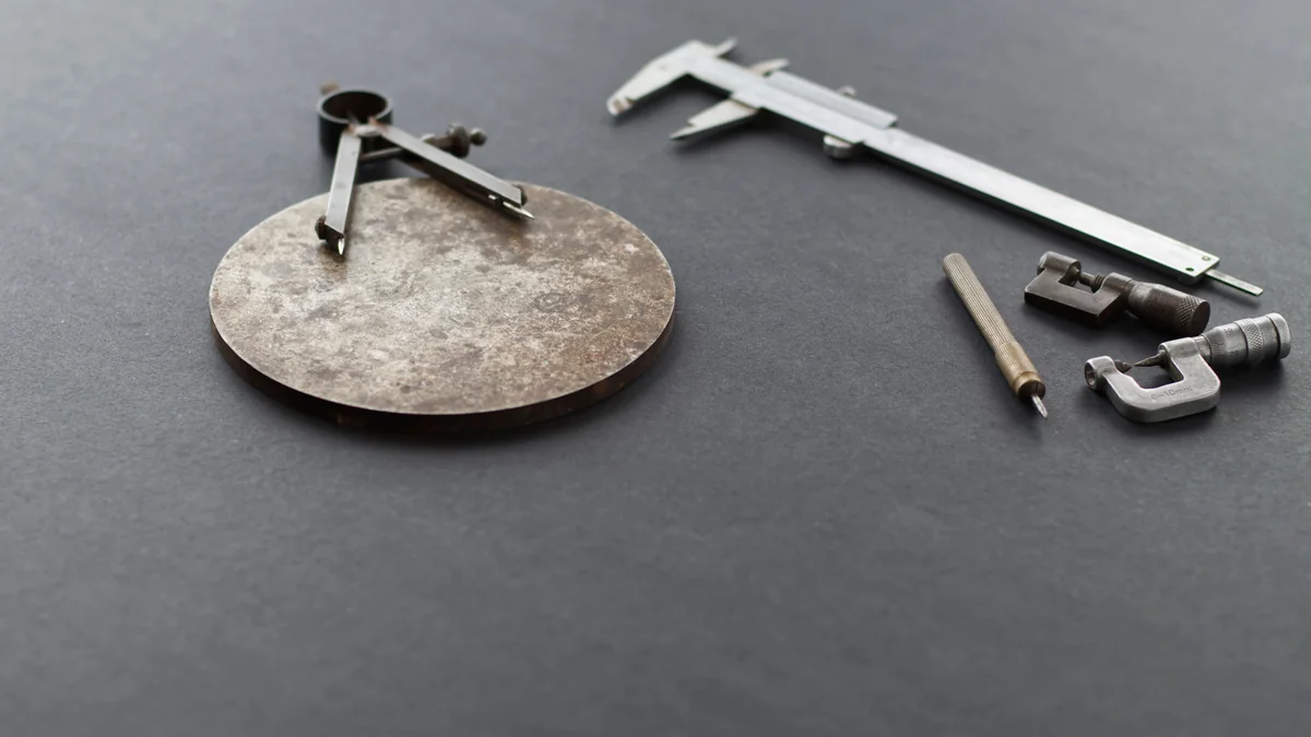 Precision calipers and measuring instruments arranged on a workshop surface