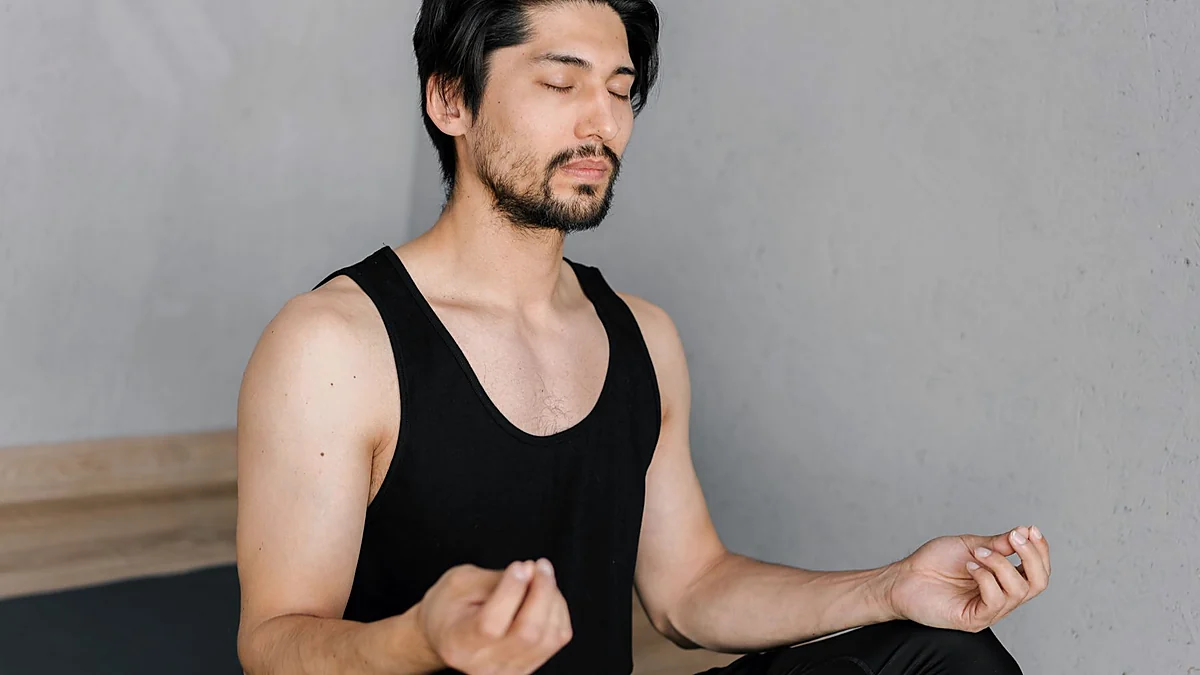 Man practicing calm breathing and pelvic floor relaxation at home